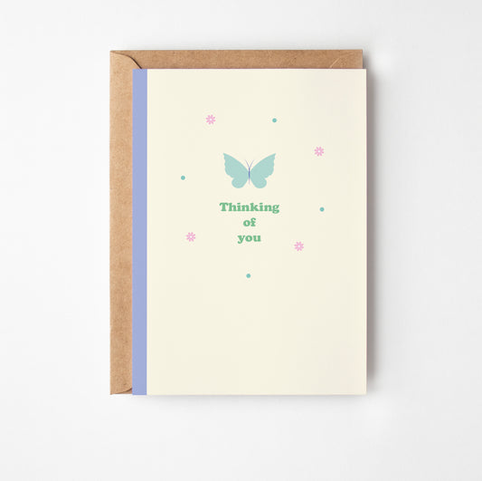 Greeting card with butterfly design and text 'Thinking of you' on a white background
