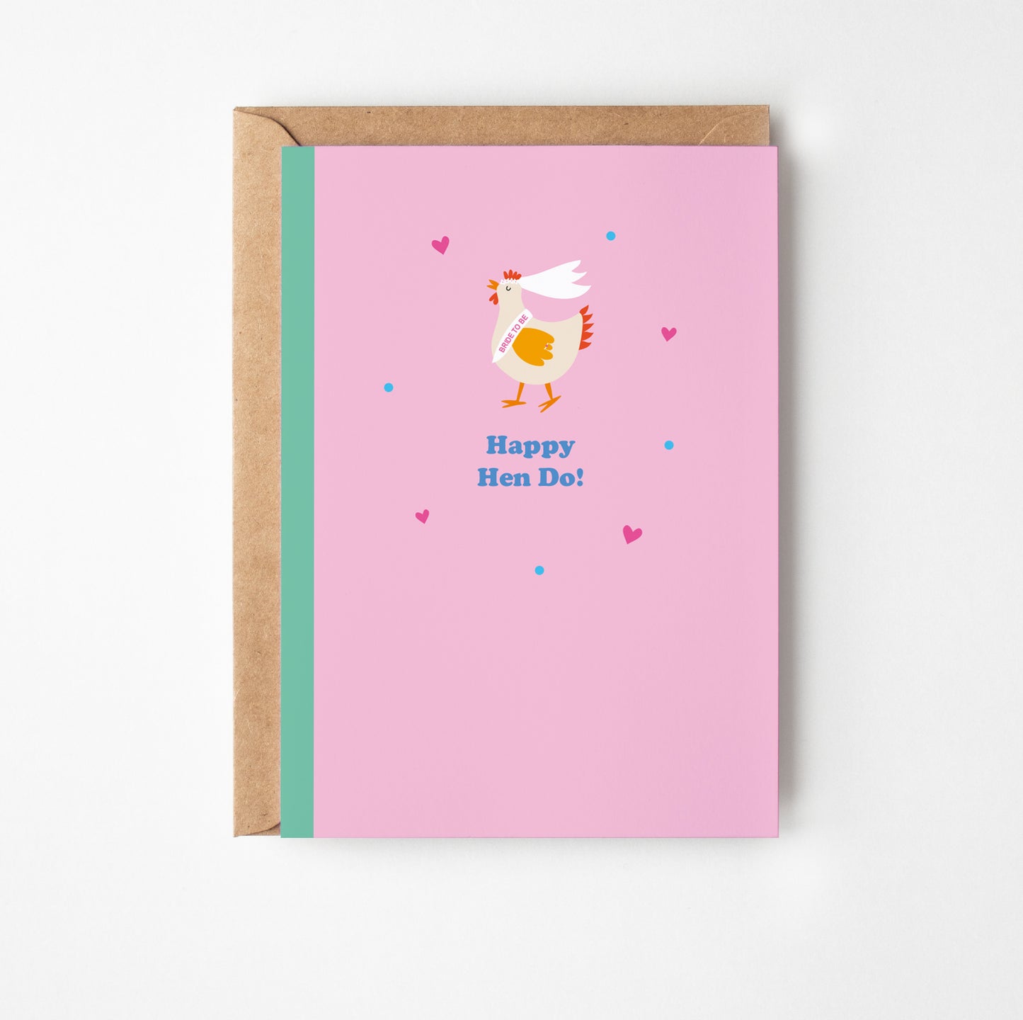Greeting card with a chicken illustration and 'Happy Hen Do!' text on a pink background, with a brown envelope.