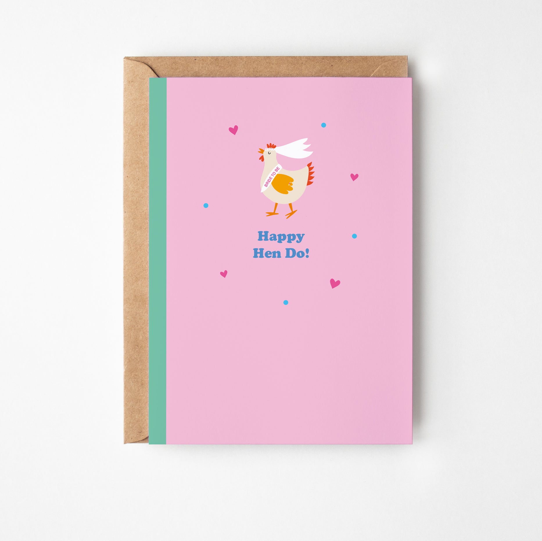 Greeting card with a chicken illustration and 'Happy Hen Do!' text on a pink background, with a brown envelope.